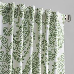 green and white curtains with an intricate design