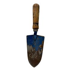 an old, rusty shovel with a wooden handle hanging from it's side on a white background