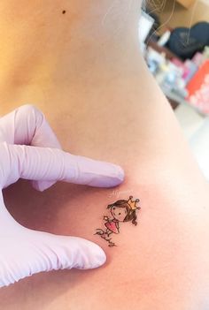 a woman with a small tattoo on her stomach is getting an injection from a doctor