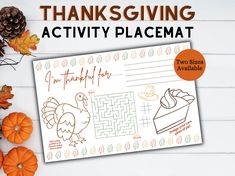 a thanksgiving activity placemat with turkeys and pumpkins on the table next to it