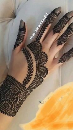 a woman's hand with henna on it and her hands painted in black