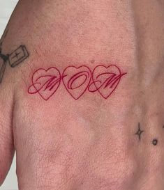 a man's hand with three hearts on it and the word love written in red ink