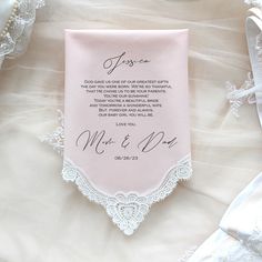 a pink wedding handkerchief with the words grand one on it and white lace around it