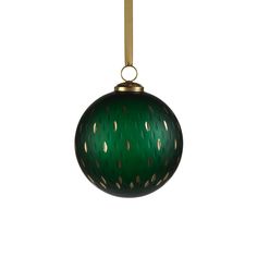 a green ball ornament hanging from a gold colored cord on a white background