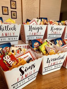 several bags of snacks sitting on top of a wooden table