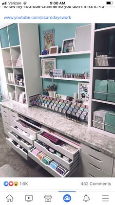 an organized craft room with lots of drawers and supplies on the counter top in front of shelves