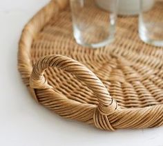 two glasses sitting on top of a wicker tray