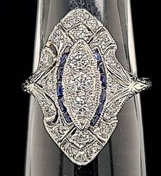 Gorgeous Vintage art deco filigree  PLATINUM  ring  circa 1930's  center set three diamonds weight 0.35ct. SI1-G bright white stones are lively brilliant. side set natural single cut DIAMONDS WEIGHT 0.65ct SI1-H  side set  natural diamonds weight 0.65ct SI1-H side set  blue sapphire weighs 0.25ct. Ring size 6.5 Resizable  This tremendous old vintage ring is in very good condition.  Appraisal available  Retail value $5,850  net Art Deco Collectible Diamond Ring, Collectible Art Deco Diamond Ring, Art Deco Diamond Ring With Prong Setting, Antique Sapphire Jewelry With Single Cut Diamonds, Vintage Diamond White Sapphire Jewelry, Vintage Sapphire Jewelry In Diamond White, Art Deco Sapphire Diamond Ring In Diamond White, Art Deco Platinum Sapphire Ring With Diamond Cut, Art Deco Sapphire Ring In Platinum