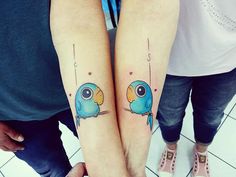 two people with matching tattoos on their arms