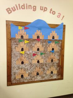 a child's bulletin board with sandcastles on it and the words building up to 8