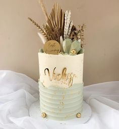 there is a cake that has been decorated with gold and green decorations on top of it