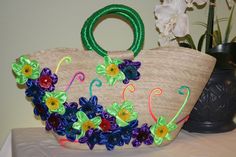 a handbag decorated with flowers on a table