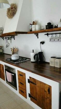 a kitchen with wooden cabinets and white walls