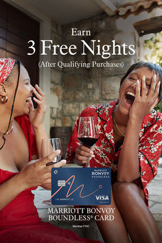 two women laughing while holding wine glasses and talking on their cell phones with the caption, earn 3 free nights after qulifying purchases