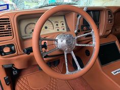 the interior of an orange car with dashboard and steering wheel