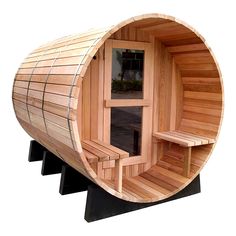 a wooden barrel sauna with benches on the outside and windows in the inside, set against a white background