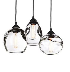 three glass pendant lights hanging from the ceiling