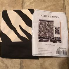 zebra - print curtains are on the floor next to a piece of paper that says zebra brown