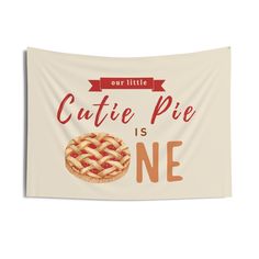 a white wall tapestry with an image of a pie and the words cutie pie is one