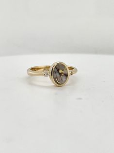 Golden quartz is prized for its unique and individual crystal patterns, and this particular ring was made and designed by Arizona based artist James Hawkes.  All set into 14k yellow gold, and accented with two diamond rounds, this ring has a delicate look but with plenty of metal integrity for everyday wear.  Currently this ring is a size 6.25, but please inquire about having it sized to you! Unique Oval Diamond Ring With Accents, Unique Oval Yellow Gold Diamond Ring, Fine Jewelry In Yellow Gold With Natural Inclusions, Timeless Gold Diamond Ring With Accent Stones, Yellow Gold Jewelry With Natural Inclusions For Anniversary, 14k Gold Rings With Natural Inclusions For Gift, Gold Rings With White Topaz And Accent Stones, Unique Gold Oval Diamond Ring, Gold Oval Diamond Ring With Unique Style