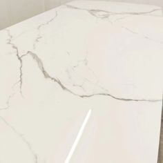 a white marble counter top in a bathroom