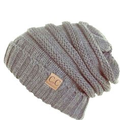 a knitted beanie hat with the word c c on it, in grey