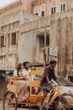 three people riding on the back of a yellow bike with a side car attached to it