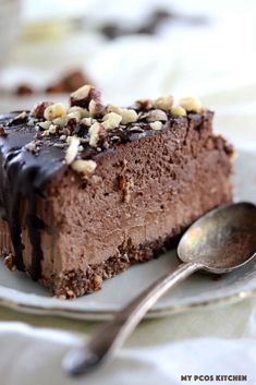 a piece of chocolate cake on a plate with a spoon