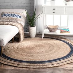 a bedroom with a bed and rugs on the floor