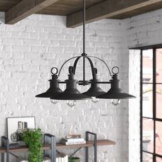 an industrial style chandelier hangs from the ceiling