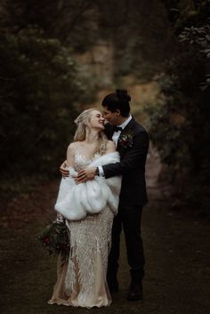 a bride and groom are kissing in the woods at their fall wedding photo by wild connections photography