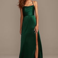 a woman in a long green dress with a slited skirt and high slits