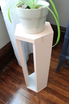 a white planter sitting on top of a wooden table