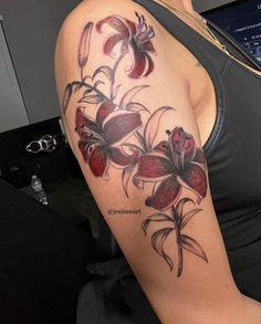 a woman's arm with flowers on it