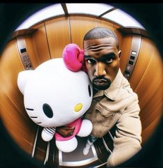 a man holding a hello kitty stuffed animal