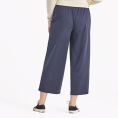 Get comfy in our take on wide-leg cropped pants, made from our signature, stretchy Crusher-FLEX jersey fabric. These relaxed bottoms are perfect for everything from lounging to running errands. 92% USA Grown Cotton, 8% Spandex 7.08oz Mid-weight cotton/spandex jersey, garment washed for softness. Elastic encased self waistband with drawcord. Slash pockets with self binding. Life Is Good® twill patch. 24" Inseam. Imported | Life is Good Women's Solid Crusher-FLEX Crop Pants T-Shirt in Inkwell Blue Pull-on Style Comfort Stretch Cropped Pants, Casual Pull-on Cropped Leg Capris, Stretch Cropped Leg Pull-on Bottoms, Non-stretch Cropped Leg Capris With Pockets, Comfort Stretch Cropped Leg Pull-on Pants, Casual Trends, Wide Leg Cropped Pants, Boxy Tee, Graphic Tees Vintage