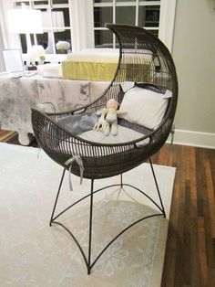 a wicker chair sitting on top of a white rug in front of a window