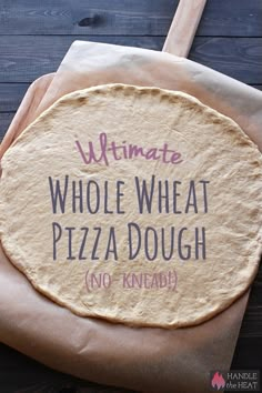 an uncooked pizza crust with the words ultimate whole wheat pizza dough written on it