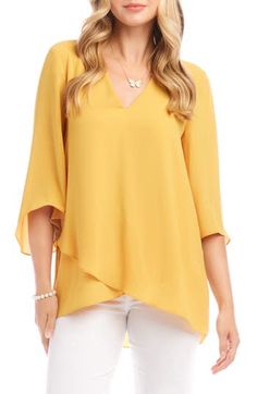 An elegant top of silky, lightweight crepe delivers elegant movement with its angled flare sleeves and fluttery asymmetrical hemline that dips low in back. 25 1/2" length (size Medium) V-neck Three-quarter sleeves Back yoke with gathering Crossover high/low hem 100% polyester Dry clean or hand wash, line dry Made in the USA of imported fabric Women's Clothing Flowy V-neck Viscose Blouse, Flowy V-neck Top For Workwear, Elegant Asymmetrical Solid Blouse, Elegant Asymmetrical Hem Tops For Work, Elegant Spring Crepe Tops, Elegant Summer Tops With Draped Sleeves, Elegant Tops With Draped Sleeves For Summer, Asymmetrical Viscose Top For Spring, Chic Viscose Tops With Asymmetrical Hem