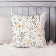 a white pillow sitting on top of a bed next to a wooden headboard and pillows