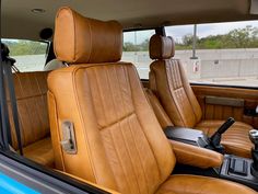 the interior of a car with tan leather seats