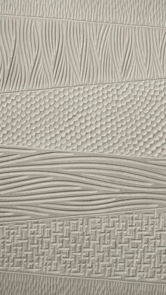 a close up view of a wall made out of white wood planks with wavy lines