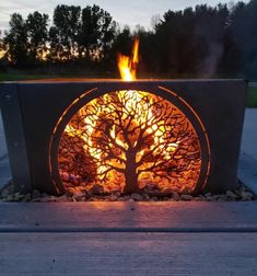 an outdoor fire pit with a tree in the center