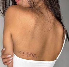 the back of a woman's shoulder with words on it that say see the good