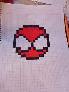 an image of a deadpool pixel art work on paper with pencils and crayons