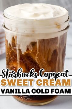 a jar filled with ice cream and topped with whipped cream, caramel swirls