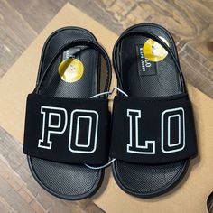 Finish Your Look With A Preppy Beach Vibe In The Polo Ralph Lauren Logo Slide Sandal. These Slides Are Constructed With An Attached Logo Adorned Wide Band Across The Top, In An Open-Toe, Slip-On Construction, Making Them A Perfect Anytime Grab Casual Non-slip Sandals For School, Casual Sandals For School In Spring, Polo Slides, Polo Ralph Lauren Slippers, Black Low-top Slides With Rubber Sole, Black Sporty Non-slip Slides, Baby Footwear, Black Non-slip Functional Slides, Polo Ralph Lauren Shoes