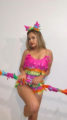 a woman in a colorful costume holding a string