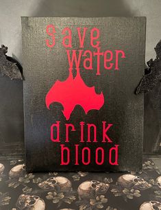 a sign that says save water drink blood with skulls on the floor and in the background