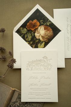 the wedding stationery is decorated with flowers